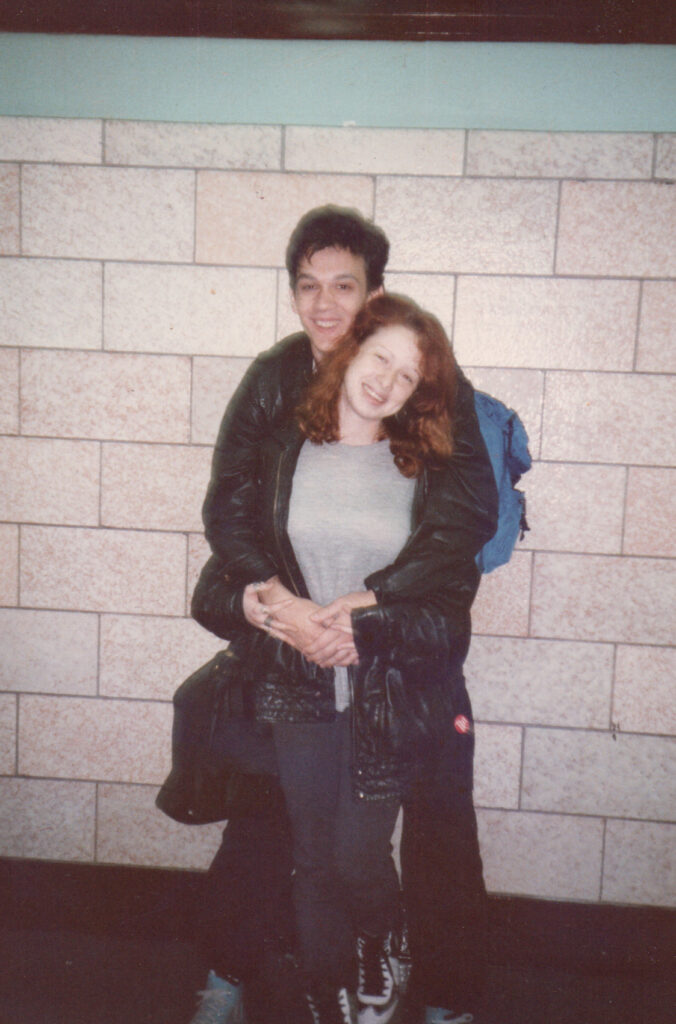 A high school boy hugs 16-year-old Janice from behind in a school hallway, 1986