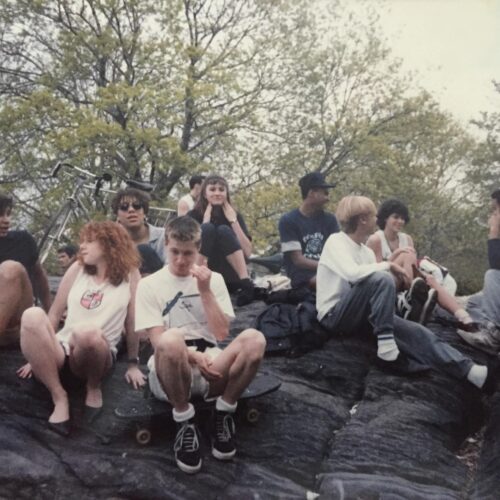 A group of teenagers sit on a rock formation in New York's Central Park, 1985