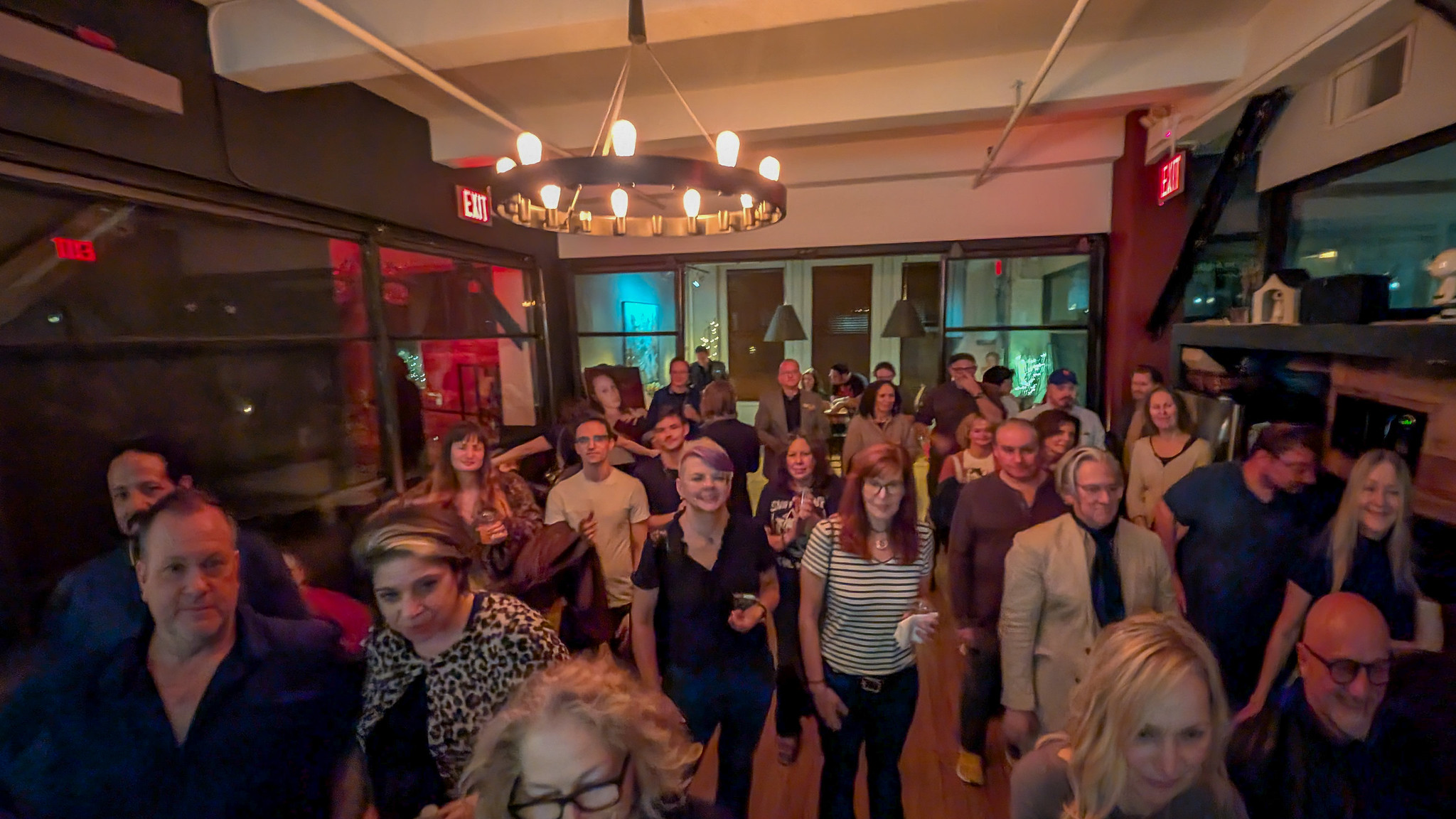 Crowd of sophisticated literary artistic types at a reading/party