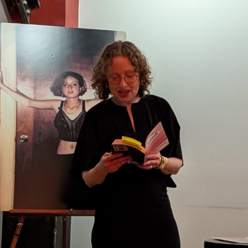Janice, present day, reads in front of a picture of Janice, age 14
